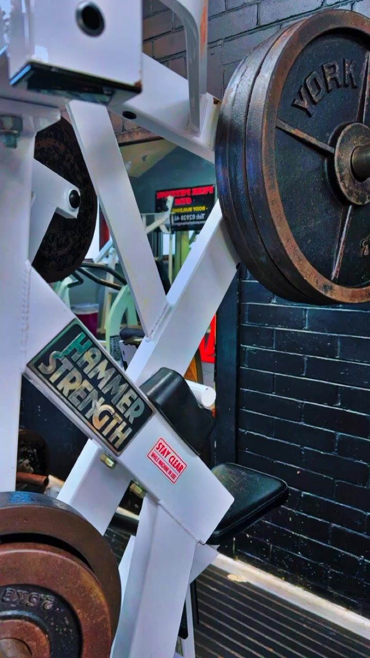 Close-up of plate-loaded equipment and stacked weight plates