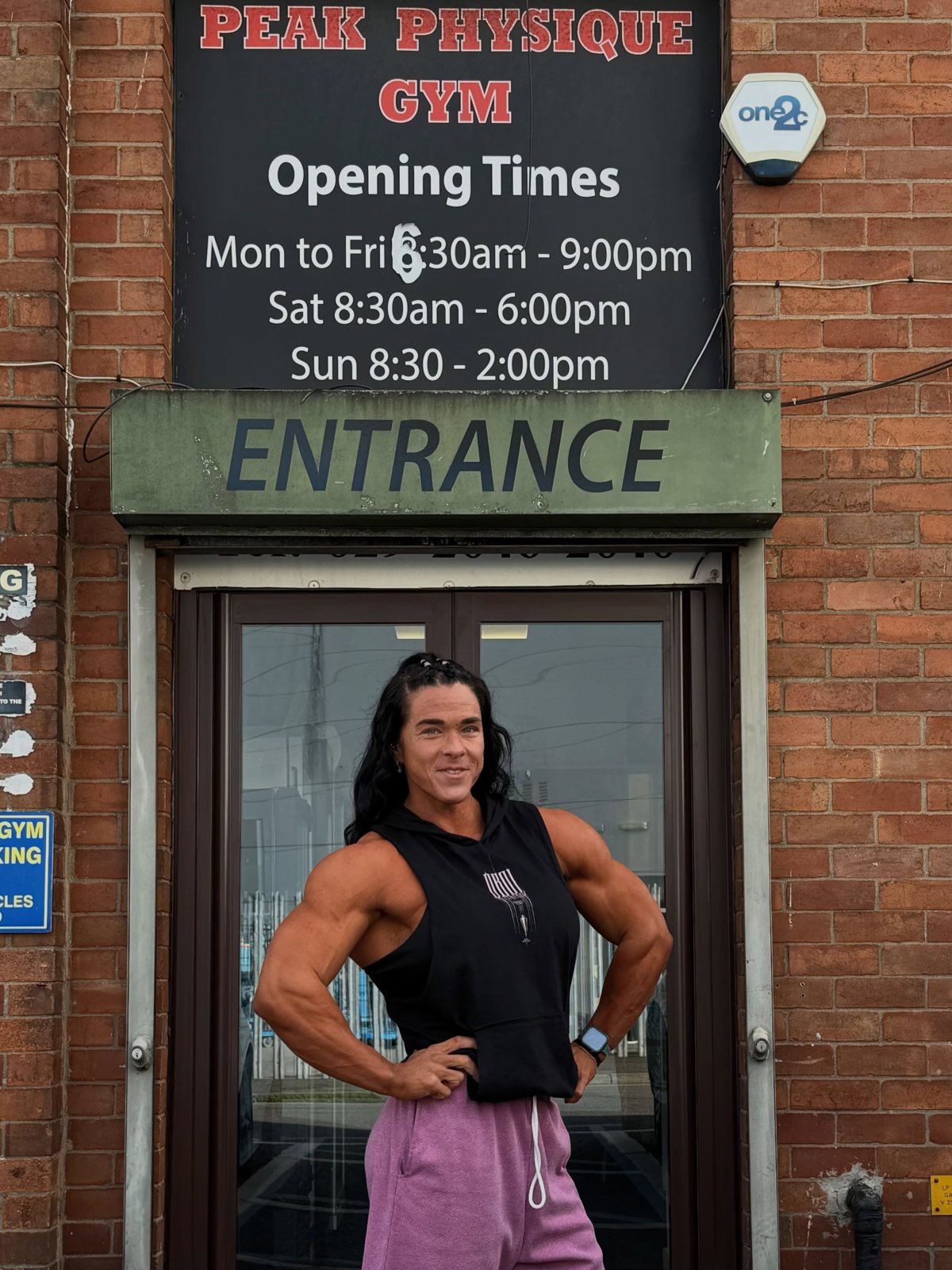The gym entrance with the opening-times sign