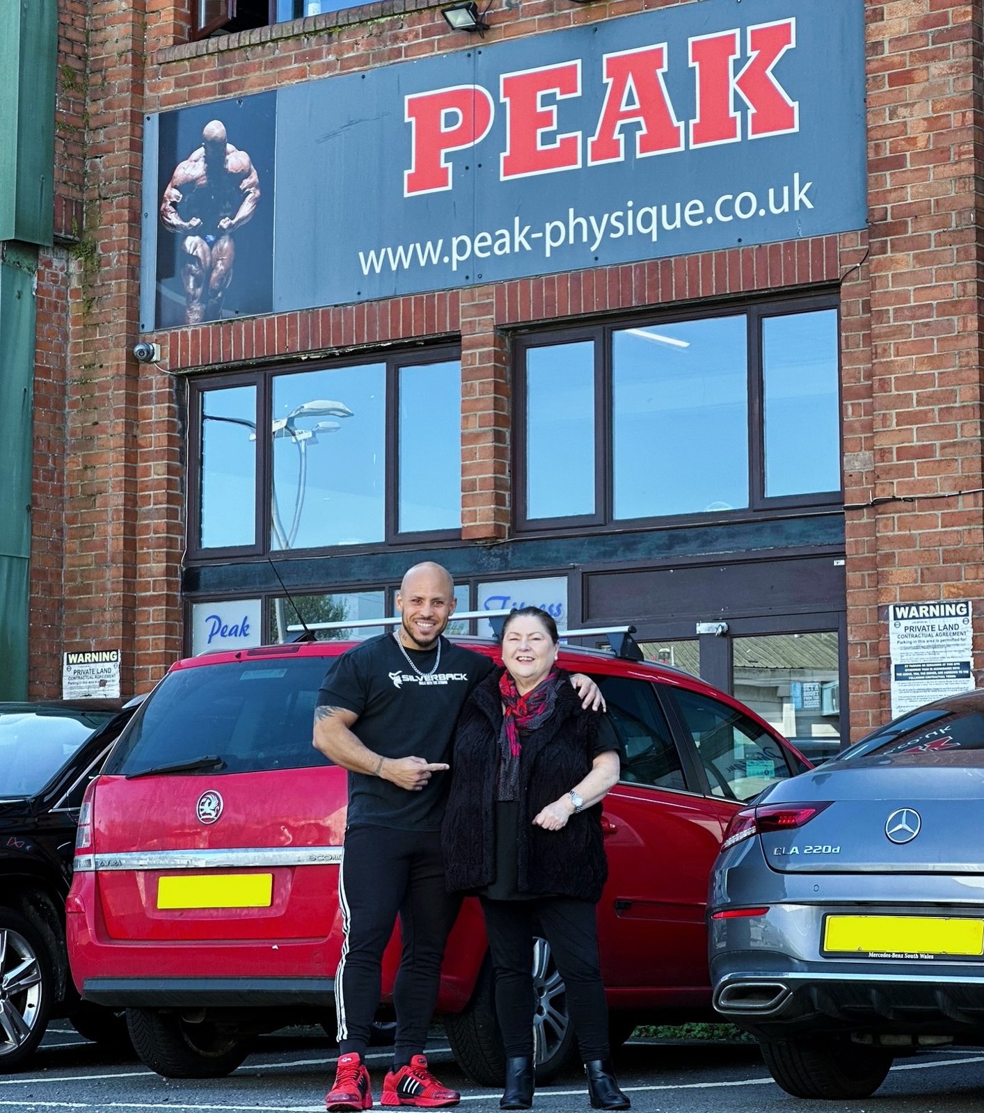The Peak Physique building with the PEAK banner above the entrance